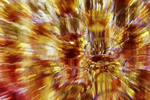 Bright abstract background based on wine glasses with motion blur focus on ce Stock Photos