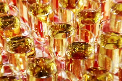 Bright abstract background based on wine glasses with motion blur focus on ce Stock Photos