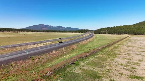 Bright aerial drone shot capturing bustling traffic on two parallel American Stock Footage 346889564