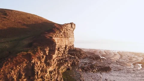 Bright aerial view of Monknash beech and cliff top Vidéo 123090996
