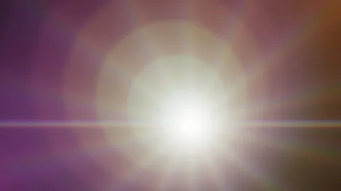 Bright anamorphic lens flare glowing and moving across a dark background. 4K Video stock 345112100