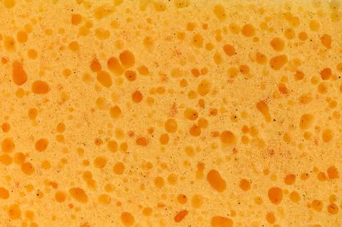 Bright and bubbly sponge texture with an organic feel showcasing vibrant ye.. Stock Photos