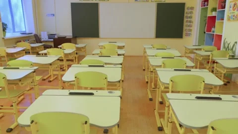A bright and clean classroom in a school equipped with desks and a chalkboard is Stock Footage 281869058