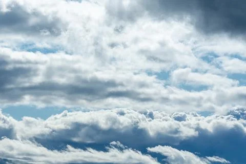 Bright and Dark Layers of Clouds in Blue Sky. Foto stock