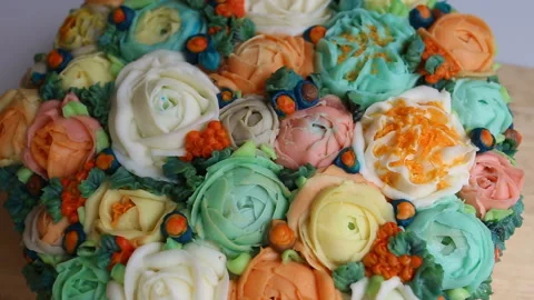 Bright and elegant wedding cake decorated with flowers of roses, Ranunculus and Stock Footage 143725573