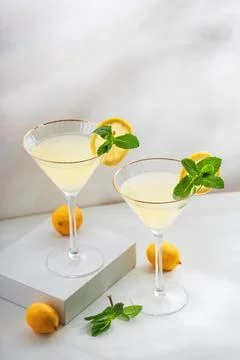 Bright and refreshing cocktail with two glasses of limoncello spritz, garni.. Stock Photos