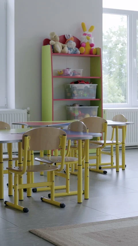 Bright and spacious classroom featuring yellow furniture, large windows allowing Stock Footage 313927363