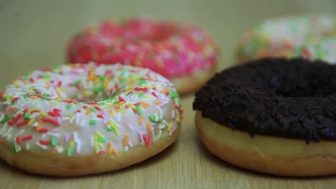Bright appetizing donuts on a wooden table Stock Footage 90303752