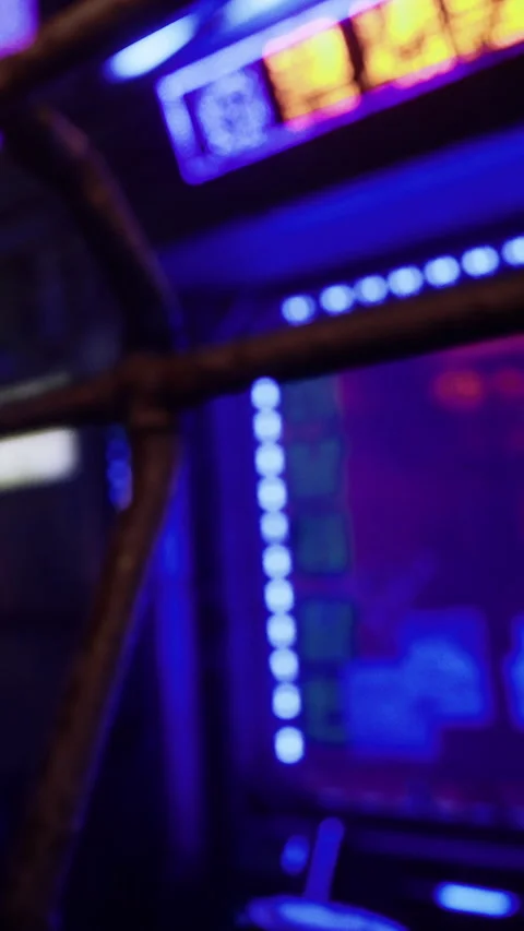 Bright arcade machine lights shine at the local gaming center in the evening Stock Footage 331444263
