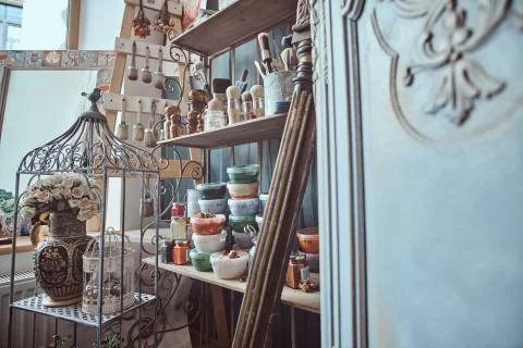 Bright artist's workshop with barocco elements, cage and flowers Foto stock