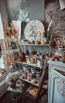 Bright artist's workshop with barocco elements, cage and flowers Foto stock