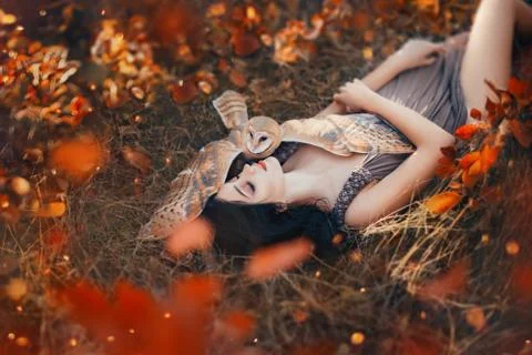 Bright autumn art photo, goddess rests in autumn orange forest under protection Stock Photos