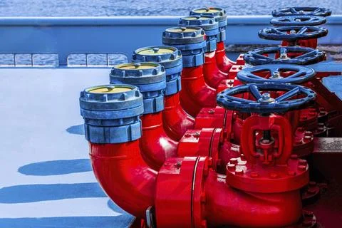 Bright background Five red fire hydrants on a fire line on a ship. fire safety Stock Photos