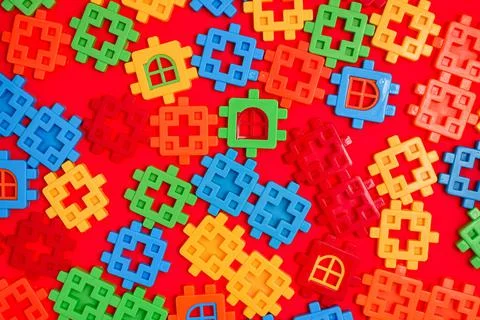 Bright background texture from multi-colored plastic fragments of a childrens Stock Photos
