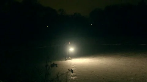 Bright ball on icy surface showcasing graceful spinning motion in silent night Video stock 347325331