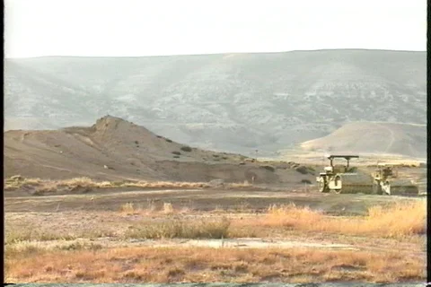 Bright Bare Hills above Work Site and Equipment Stock Footage 121338624