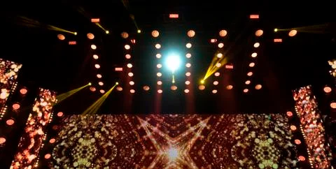 Bright beautiful rays of light on an stage before the concert. Stock Photos