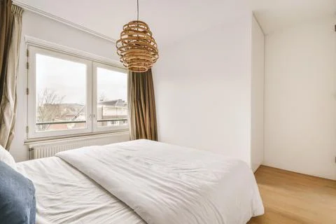 Bright bedroom with a double bed Stock Photos