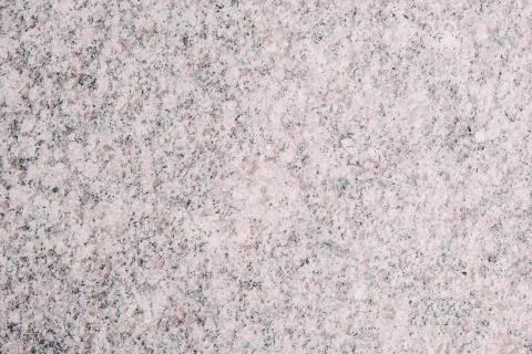Bright beige background made of solid granite. Stock Photos