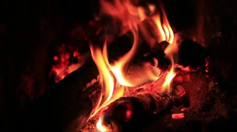 Bright blaze flare macro and poker in fire place Stock Footage 12364545