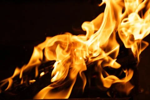 Bright blazing fire flames burning in outdoor metal brazier Stock Photos