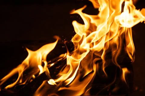 Bright blazing fire flames burning in outdoor metal brazier Stock Photos