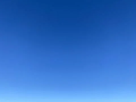 Bright blue background. Clear cloudless sky. Stock Photos