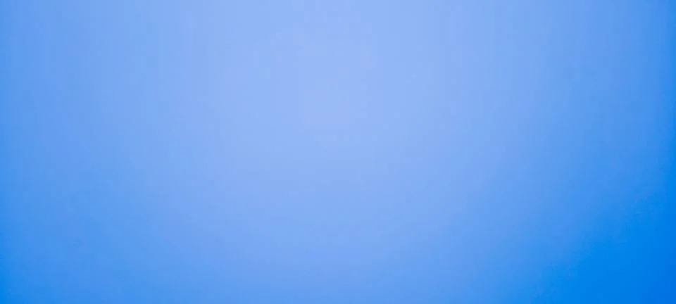 Bright blue background with a solid, uniform tone 库存照片