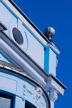 Bright blue building with decorative elements against clear sky Stock Photos
