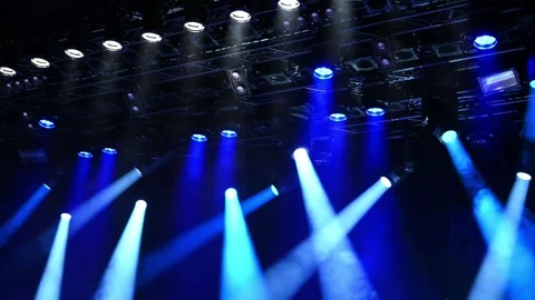 Bright blue ceiling spotlights lights through the stage fog Video stock 249936631