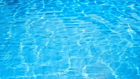 Bright blue clear water in the pool shimmers in the sun, shimmers. Stock Footage 115541202