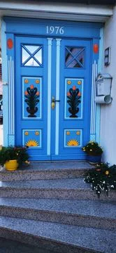Bright blue door with decorative elements Stock Photos