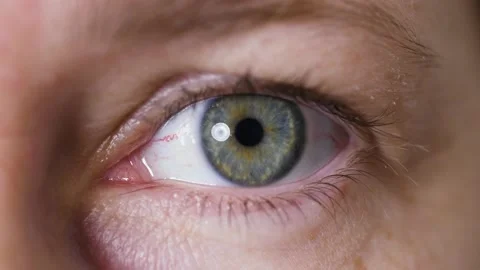Bright blue eye of middle aged Millennial woman with beautiful iris opening. Video stock 165950135