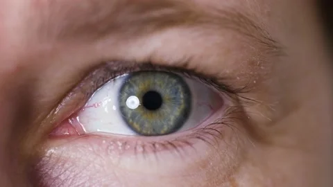 Bright blue eye of middle aged woman with natural makeup looking around. Stock Footage 165950219