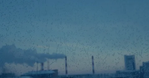 Bright blue frost pattern on a window glass. Smoking pipe of CHP on the Stockbeeldmateriaal 119758867