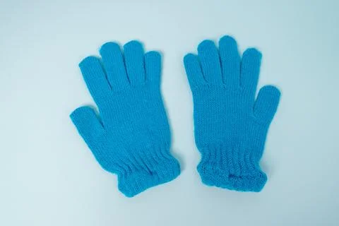 Bright blue gloves placed on a light background with open fingers showing 스톡 사진