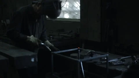 Bright blue light from welding. A man in a welding mask works with Stock Footage 135747728