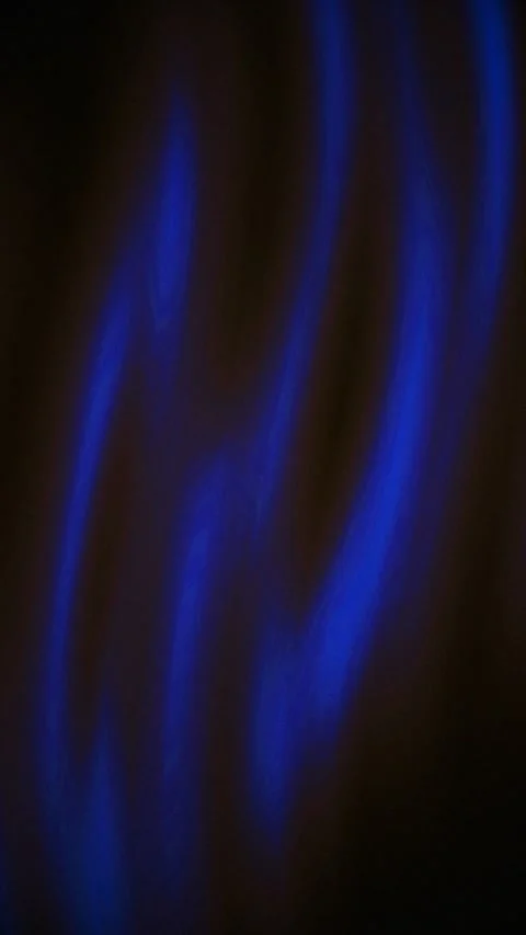 Bright blue lights shift and shimmer against a nearly black background. Video stock 324114032
