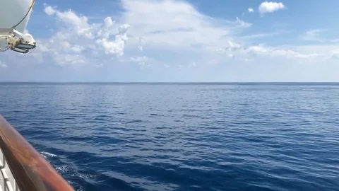 Bright blue ocean and sky skyline view from sailing ship deck Stock Footage 97179459
