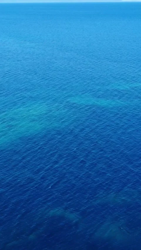 Bright Blue Ocean View With Gentle Waves and Sunlight Reflecting on the Surface Stock Footage 311111446