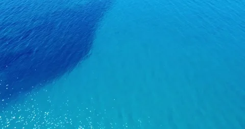 Bright Blue Ocean Waves Gently Ripple Under the Sunlight at a Serene Coastal Stock Footage 316166410