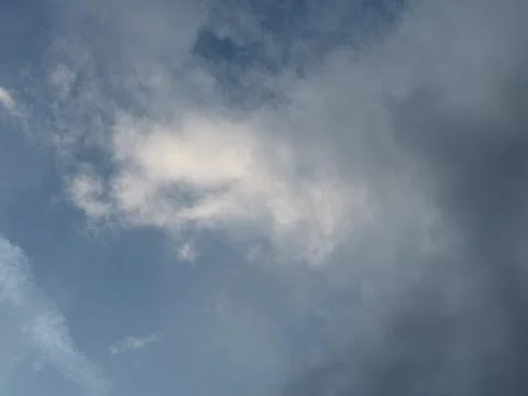 Bright Blue Opening in Dramatic Gray Clouds Stock-Fotos