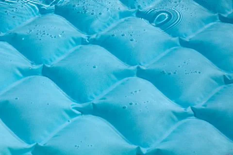 Bright blue paddling pool surface with water ripples Stock Photos