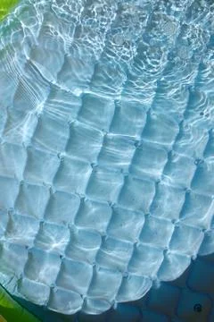 Bright blue paddling pool surface with water ripples Stock Photos