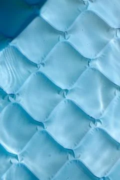 Bright blue paddling pool surface with water ripples Stock Photos