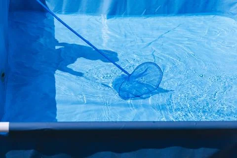 Bright blue pool being cleaned, highlighting the tranquility and beauty of clear Stock Photos