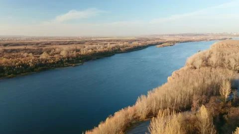 Bright blue river surrounded by yellow fields and forests. Nature and ecology Stock Footage 153094558