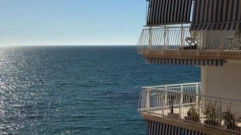 Bright blue sea sparkling under the sunlight with striped balconies Stock Footage 297373519