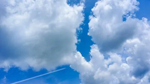 Bright blue sky and cloud texture during a clean air daytime. Stock Photos