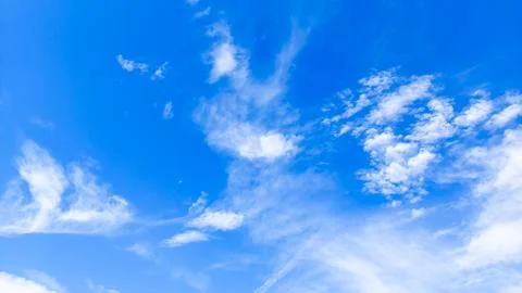 Bright blue sky background with light soft white clouds panoramic view Stock Photos